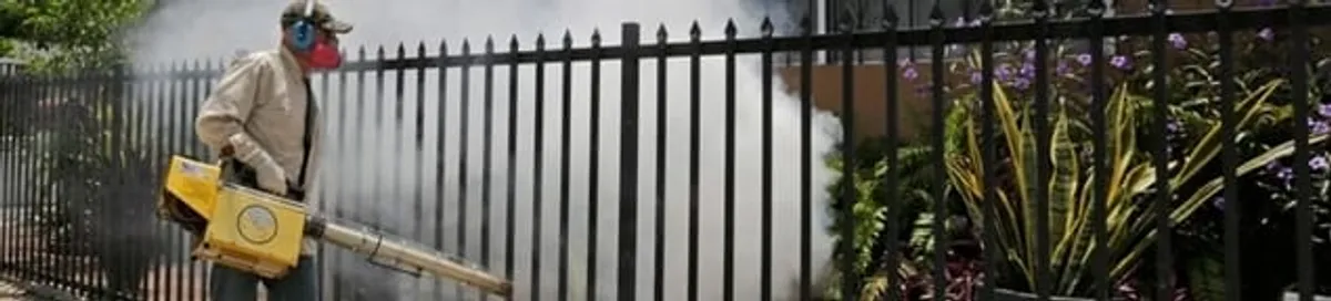 Mosquito control technician fogging a yard perimeter for mosquito reduction in Colorado Springs, CO